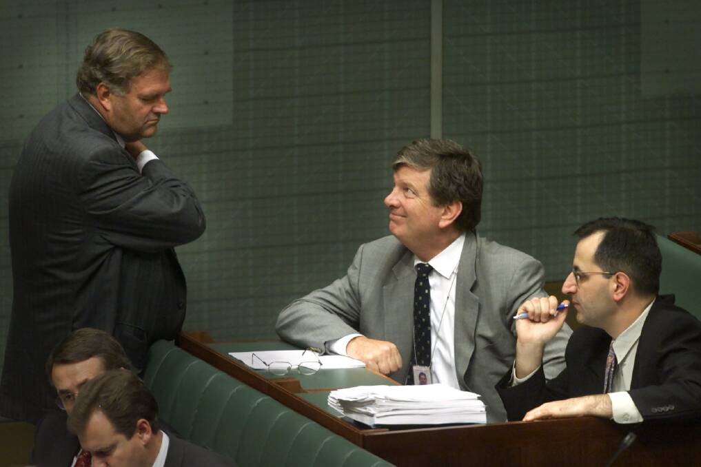 Then opposition leader Kim Beazley consults with his advisors, from right, senior advisor Michael Pezzullo and chief of staff Michael Costello during question time in 2000. Photo: Mike Bowers