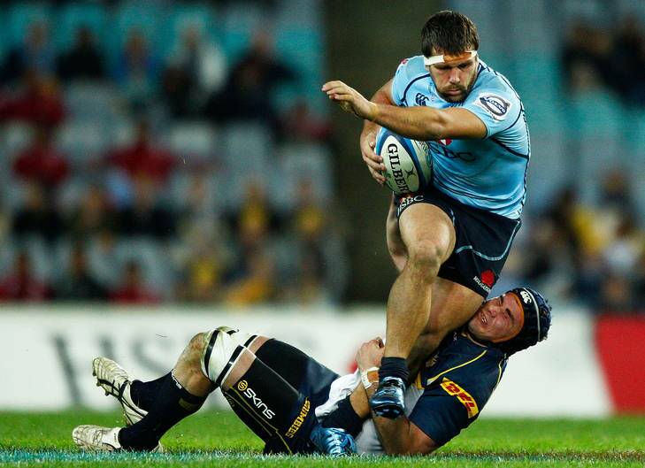 Brumbies skipper Ben Mowen brings down NSW's Chris Alcock on Saturday night. ACT great George Gregan says the club's ability to 'win ugly' will put them in good stead in the Super Rugby finals. Photo: Getty Images