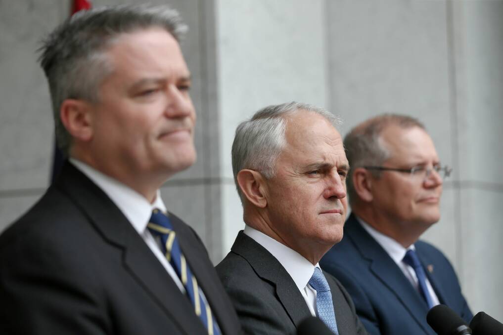 Finance Minister Mathias Cormann with Prime Minister Malcolm Turnbull and Treasurer Scott Morrison. Photo: Alex Ellinghausen