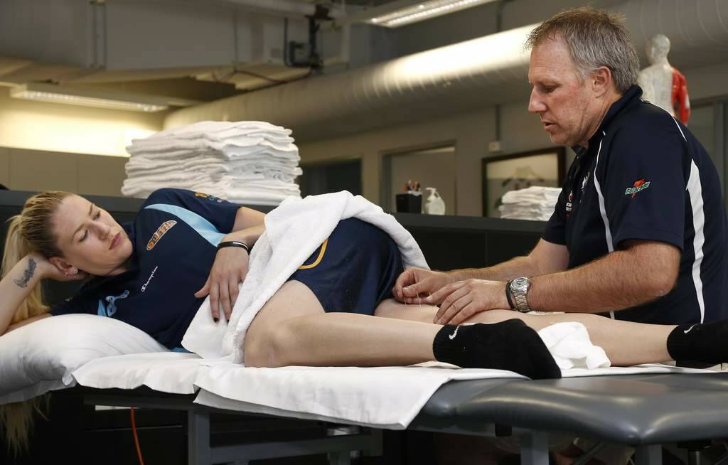 Jackson is treated by physiotherapist Tony Ward. Photo: Jeffrey Chan
