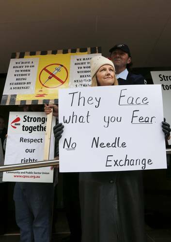 A Corrective Services ACT officer with a family member outside Fair Work Australia office protesting the proposed Needle Exchange program at the Alexander Maconochie Centre. Photo: Jeffrey Chan