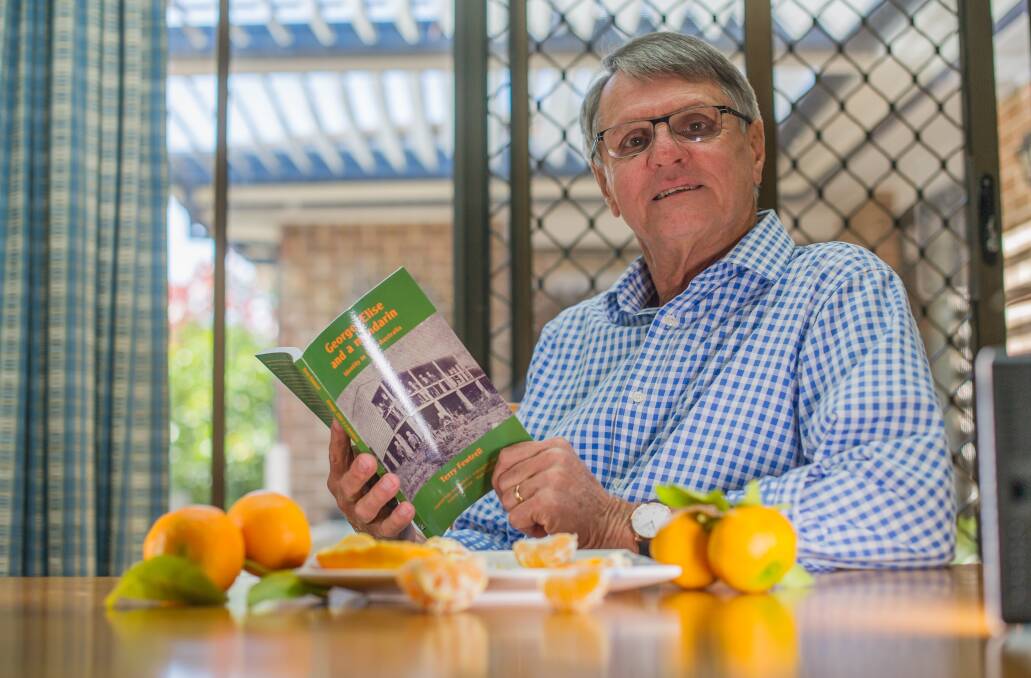 North Lyneham's Terry Fewtrell with some rare Fewtrell's early mandarins, and the book George, Elise and a Mandarin.  Photo: Karleen Minney