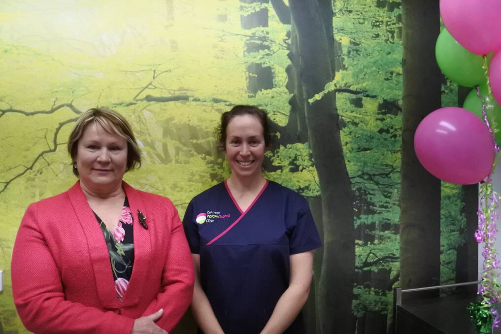 Liberal Member for Brindabella Nicole Lawder and Brindabella Podiatry owner Nicole Hart in the new Canberra Ingrown Toenail Clinic, which features a serene, green scene.