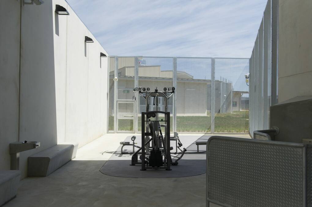 Gym equipment sits in the middle of a concrete courtyard. Photo: Jay Cronan