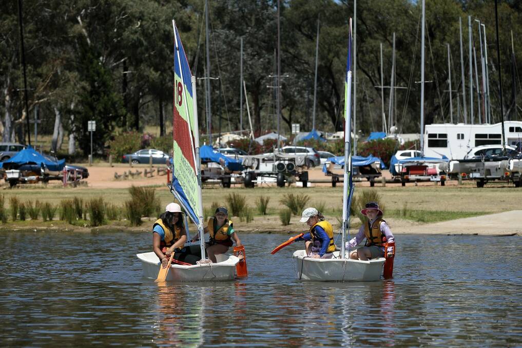 News.  Hot Weather, Kids enjoying the warm weather on the water at Lake Burley Griffin at the Canberra Yacht Club during the School Holiday Sailing School Tackers Program.  from left,  Aneesa Saadat 11 of Forde, Poppy Smith 8 of Griffith, Ingrid Shelton Agar 9 of Ainslie and Kalea Ford 9 of Bruce on the water. 14 December 2015.  Canberra Times photo by Jeffrey Chan. Photo: Jeffrey Chan