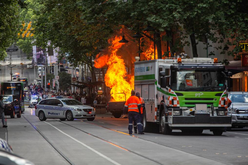 The scene in Bourke Street on Friday where Hassan Khalif Shire Ali was shot by police after setting a vehicle alight and stabbing multiple people. Photo: Stuart Gaut
