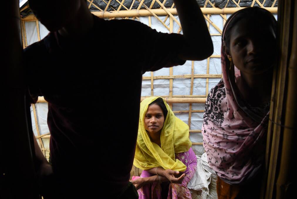 A Rohingya woman sits outside her shelter. Photo: Kate Geraghty