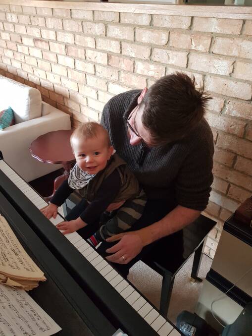 Elliot Paterson, with dad Hugh, loves music. Photo: Supplied