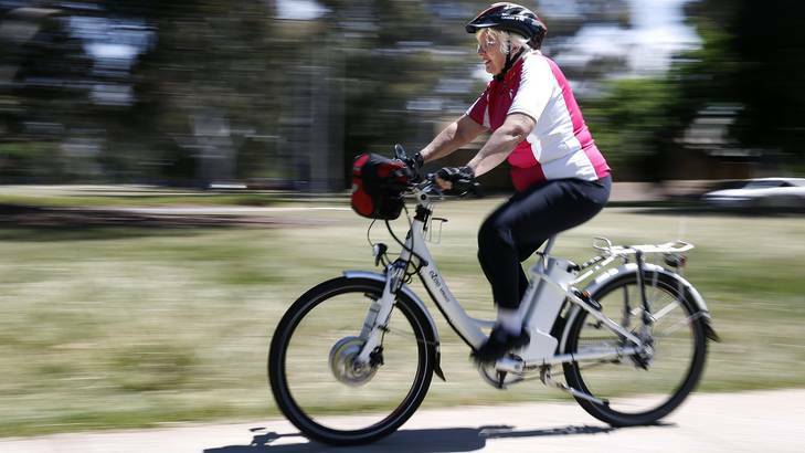 Julia Widdup from Hackett going for a ride on her  electric bicycle. Photo: Jeffrey Chan