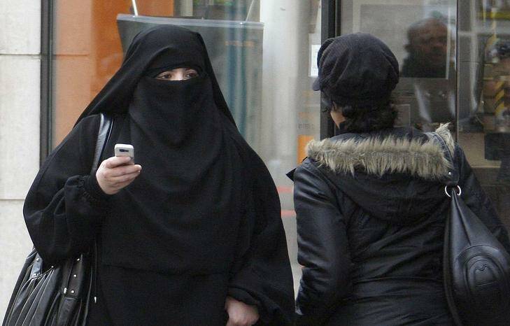 A woman wears a burqa as she walks on a street in Saint-Denis, near Paris in this April 2, 2010 file photograph. France's ban on full face veils, a first in Europe, went into force on April 11, 2011, exposing anyone who wears the Muslim niqab or burqa in public to fines of 150 euros ($216). REUTERS/Regis Duvignau/Files (FRANCE - Tags: POLITICS RELIGION) Photo: REGIS DUVIGNAU