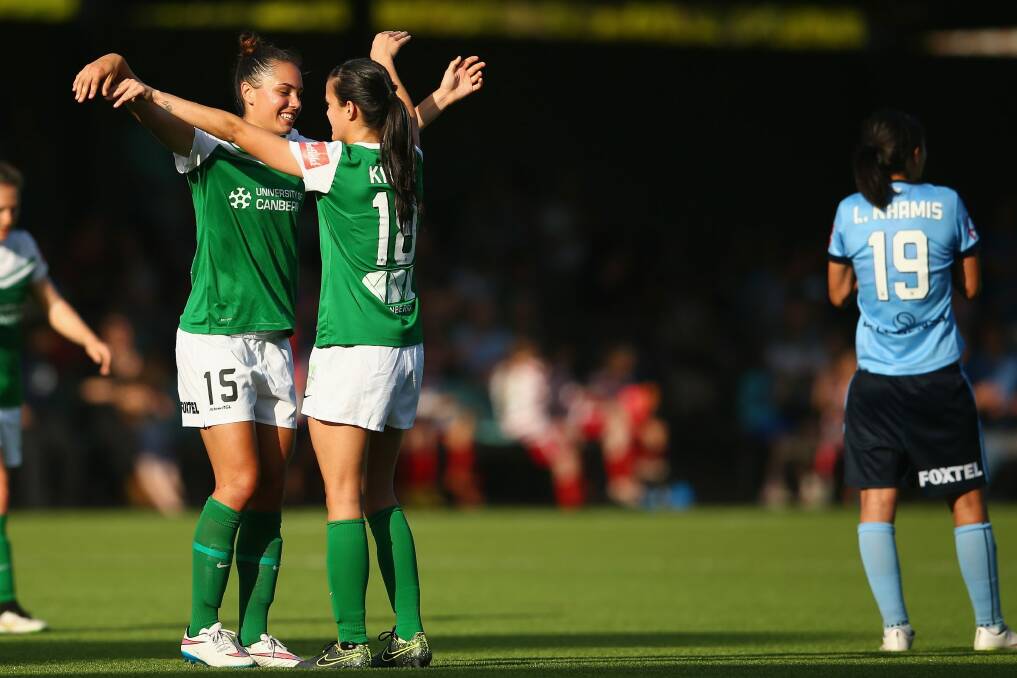 Canberra United defenders Emma Checker and Rebecca Kiting celebrate their 1-0 victory against Sydney FC earlier this season. Photo: Mark Kolbe