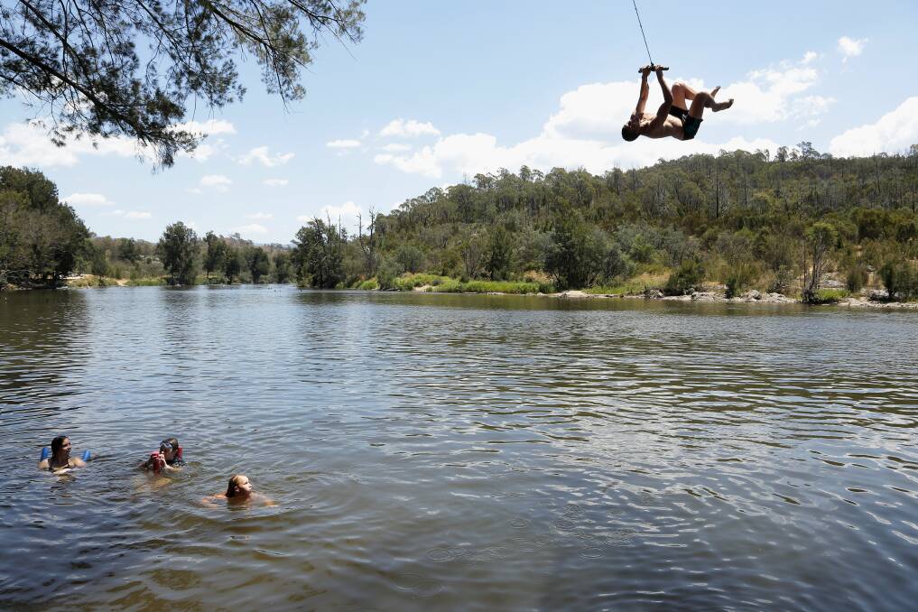 Young people at the Casuarina Sands swing in 2014. For many years, the spot has been one of Canberra's favourites for swimming. Photo: Jeffrey Chan