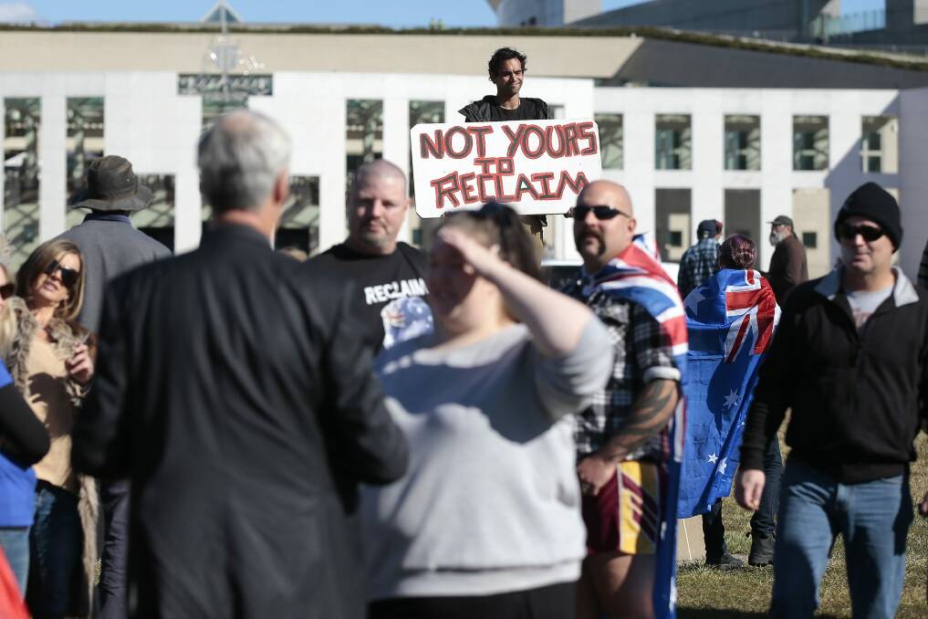 Aboriginal Tent Embassy caretaker Roxley Foley behind the crowd at the Reclaim Australia rally.   Photo: Jeffrey Chan