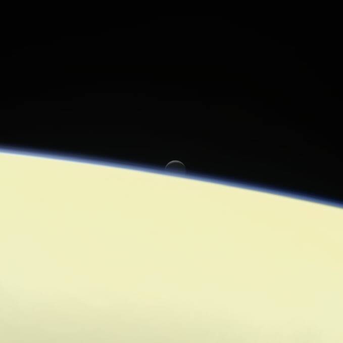 The moon Enceladus sets behind Saturn. This is one of the last images Cassini took. Photo: NASA Jet Propulsion Laboratory - Caltech