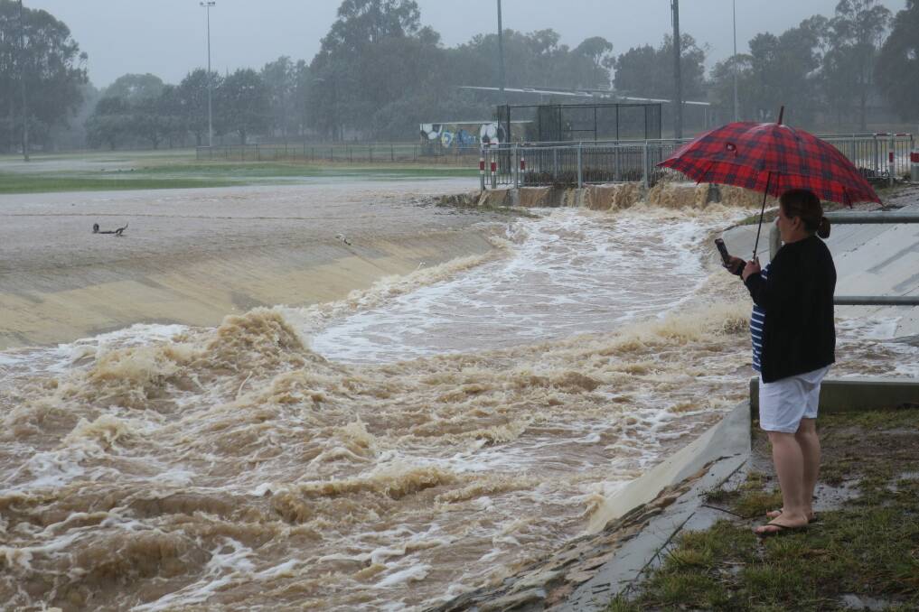 The storm water drain near Dickson oval was overflowing after heavy rain in February. Photo: Scott Hannaford