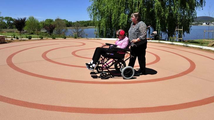 Robyn Franklin pushes her daughter Michelle Franklin around t newly opened Wallace Labyrinth at Clare Holland House. Photo: Jay Cronan