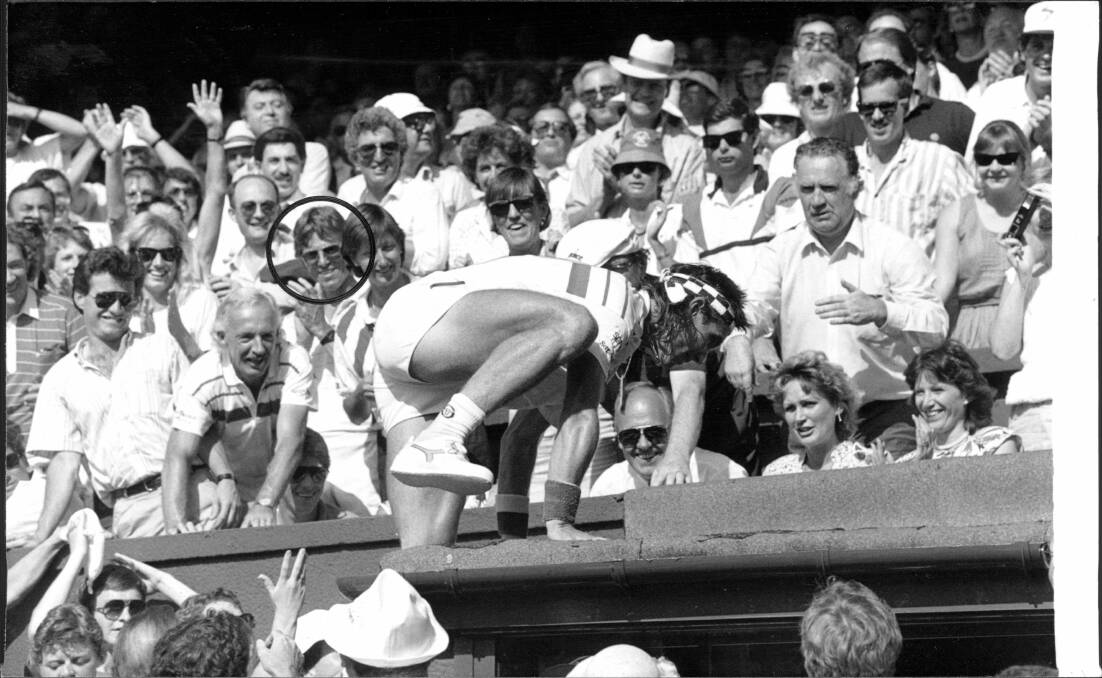 Pat Cash scales the Wimbledon wall after winning in 1987, with Jeff Bond (circled) in his players box. Photo: Solo Syndication