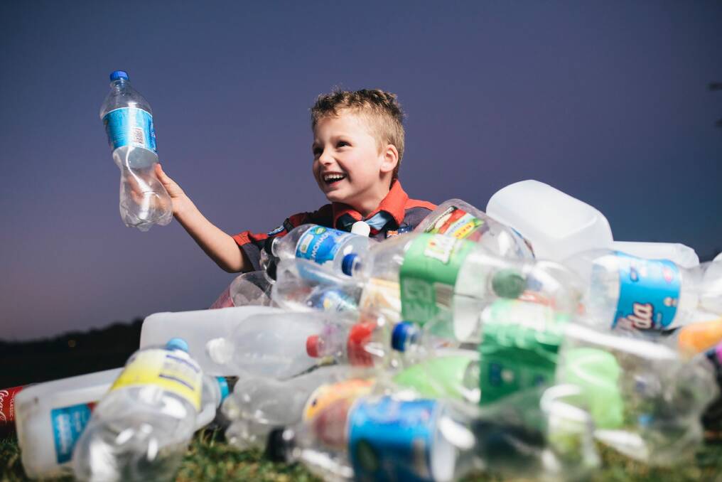 Lake Ginninderra scout Oliver Georgiou, 6, with a pile of bottles and cans. Groups like the scouts would benefit from the introduction of an ACT container deposit scheme. Photo: Rohan Thomson