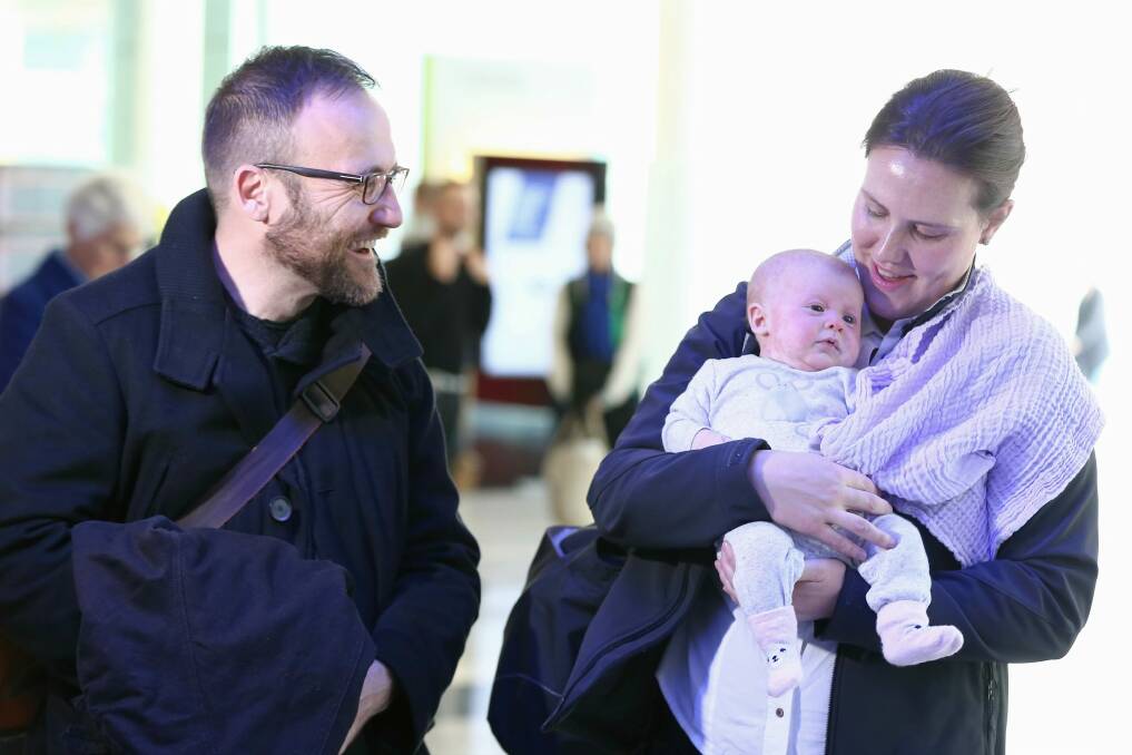 New father Greens MP Adam Bandt greets Ms O'Dwyer and Olivia at Canberra Airport, arriving for the return of Parliament this week. Photo: Alex Ellinghausen
