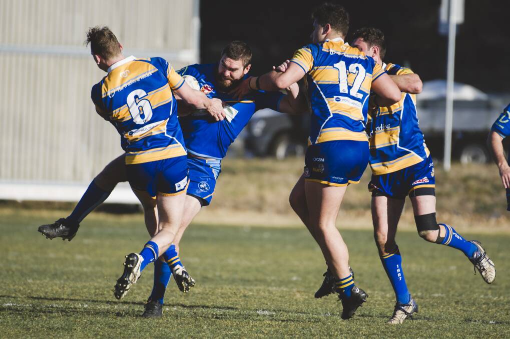 Rams Sean Maloney and Michael Gilmour stop West Belconnen's Fraser Harvey in his tracks. Photo: Jamila Toderas