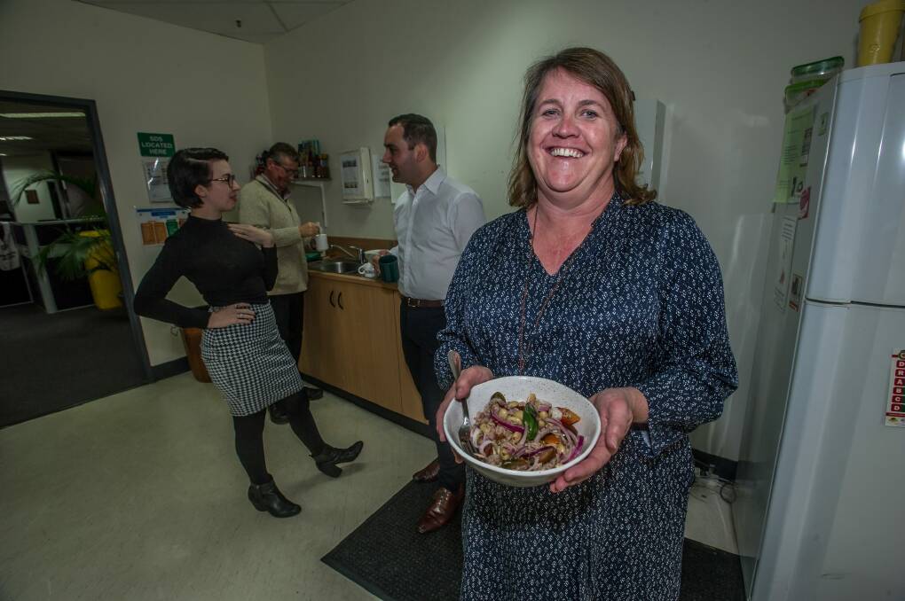 Karen Hardy (right) prepared her lunch in the Canberra Times tearoom with staff members.  Photo: Karleen Minney