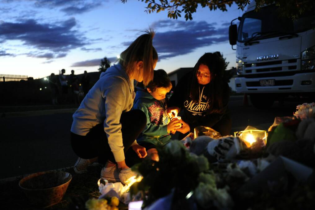 Neighbours light candles for Bradyn Dillon, who was allegedly killed by his father last year. Photo: Melissa Adams 