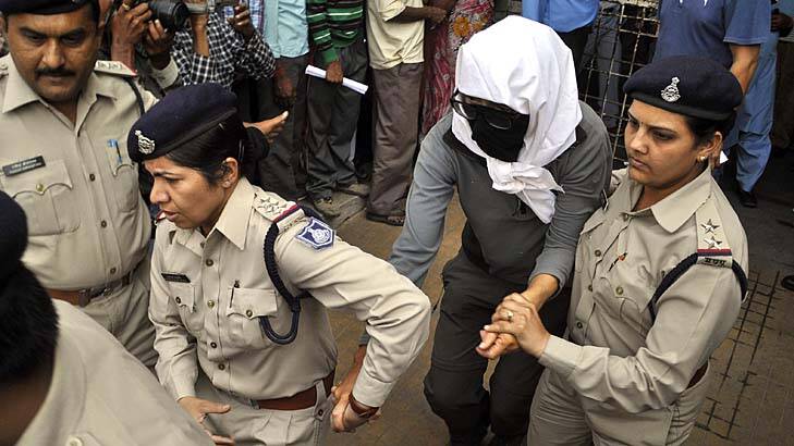 Traumatising: A Swiss woman is escorted to a medical examination at a hospital in Gwalior by police. Photo: AP