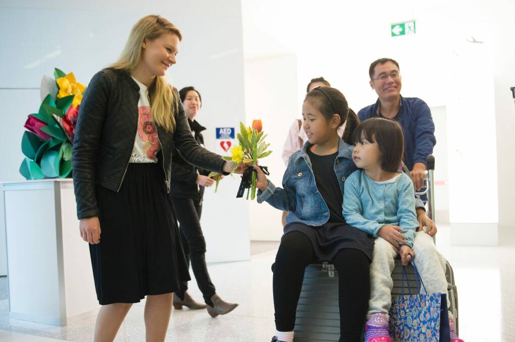 The first customers to disembark from the Capital Express were greeted with flowers Photo: Jay Cronan
