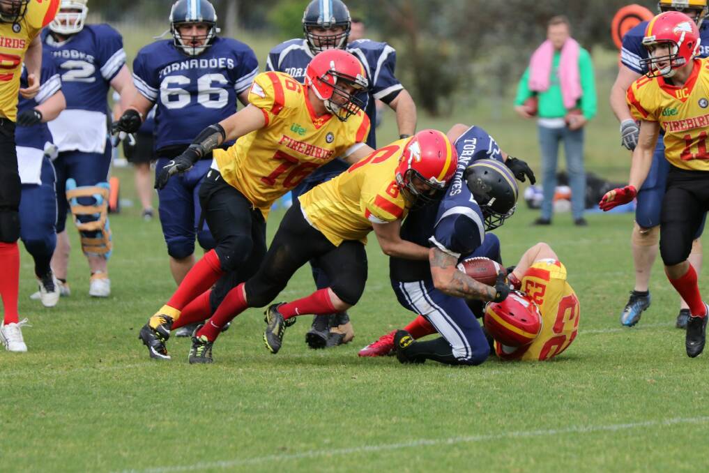 The University of Canberra Firebirds won the ACT Gridiron Capital Bowl in remarkable fashion.?Brendan Morrissey (76),?Max Murdoch (6), and Ian Lanham (23) make a tackle. Photo: Richard W Forshaw