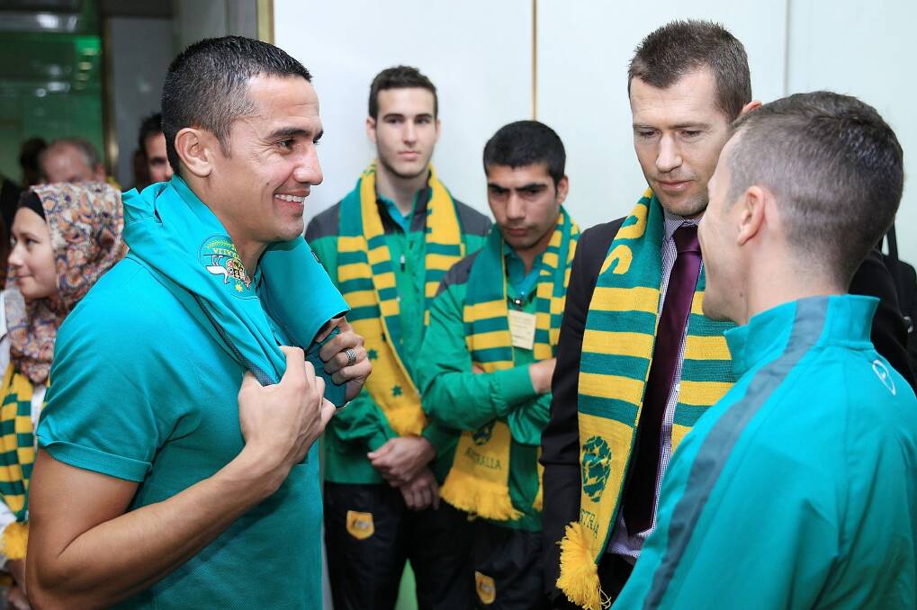 Wake-up call: Socceroos Tim Cahill and Matt McKay chat with former Socceroo Brett Emerton at Parliament House on Monday. Photo: Stefan Postles