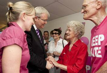 Kevin Rudd and Labor state member Kate Jones speak with locals in her Ashgrove electoral office today. Photo: Harrison Saragossi