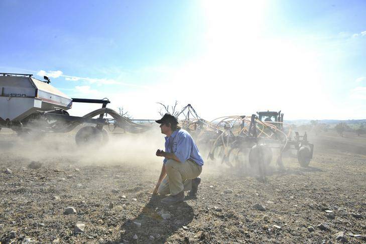 Farmer Tom Corkhill at Maneroo property near Boorowa after being contracted to sow the fields with Canola Seeds. Photo: Jay Cronan