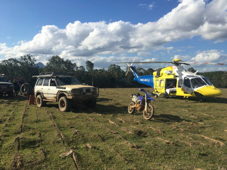 The RACQ LifeFlight helicopter lands in an open paddock on Sunday afternoon to transport an injured rider. Photo: RACQ LifeFlight