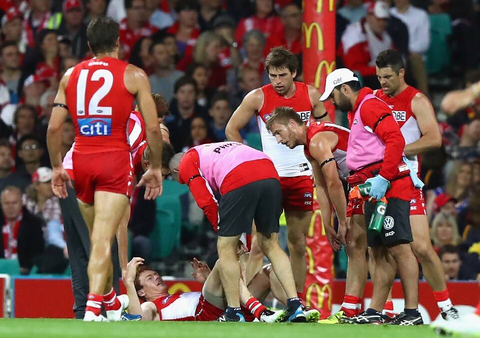 Ouch: Gary Rohan reacts after injuring his knee.