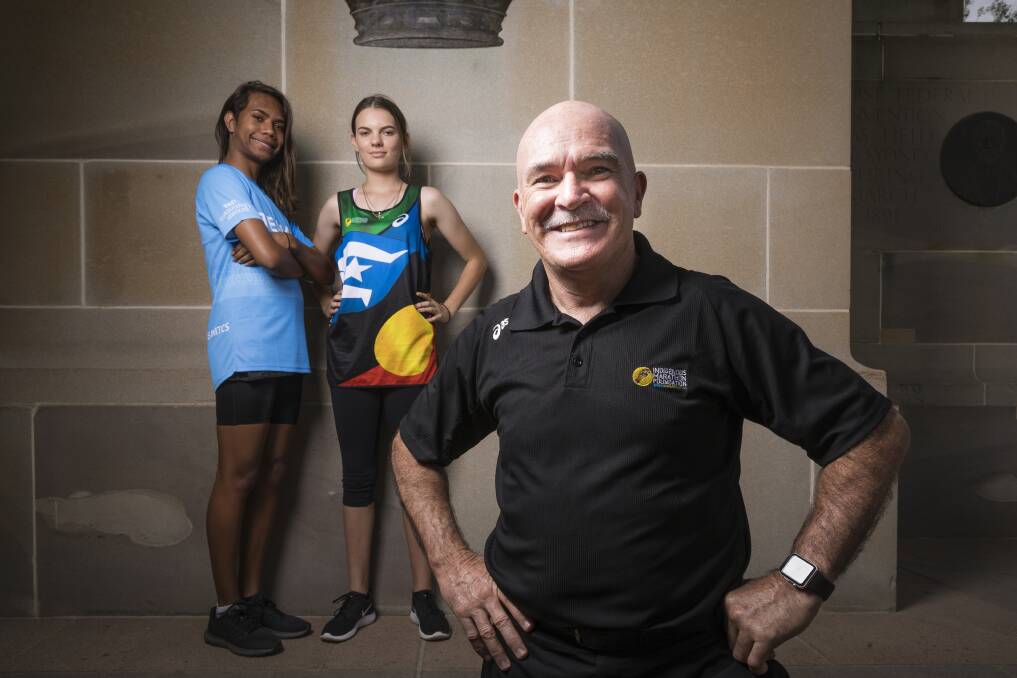 Indigenous Marathon Foundation director Robert de Castella with 15-year-old Kakadu runners Jesse Hunter and Catherine Ralph ahead of this weekend's Australian Running Festival. Photo: Sitthixay Ditthavong