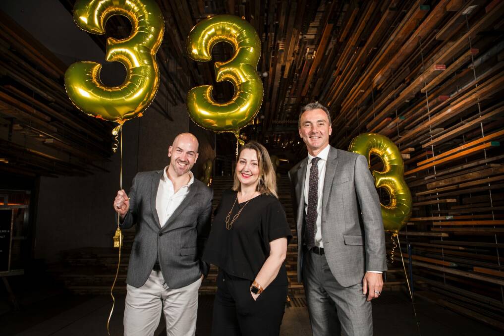 Chris Zeiher of Lonely Planet, Amanda Whitley from Her Canberra and director of the National Museum of Australia Dr Mathew Trinca celebrate Canberra being named Lonely Planet's third best city in the world to visit in 2018.  Photo: Jamila Toderas
