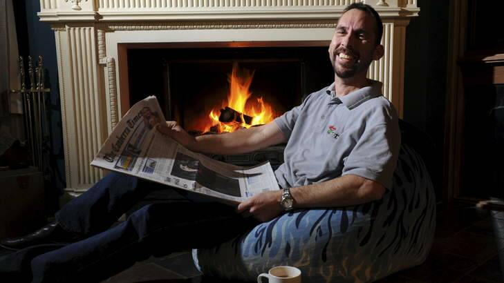 Dominic Stinziani, 44 of Higgins, in front of his open fireplace. Photo: Graham Tidy