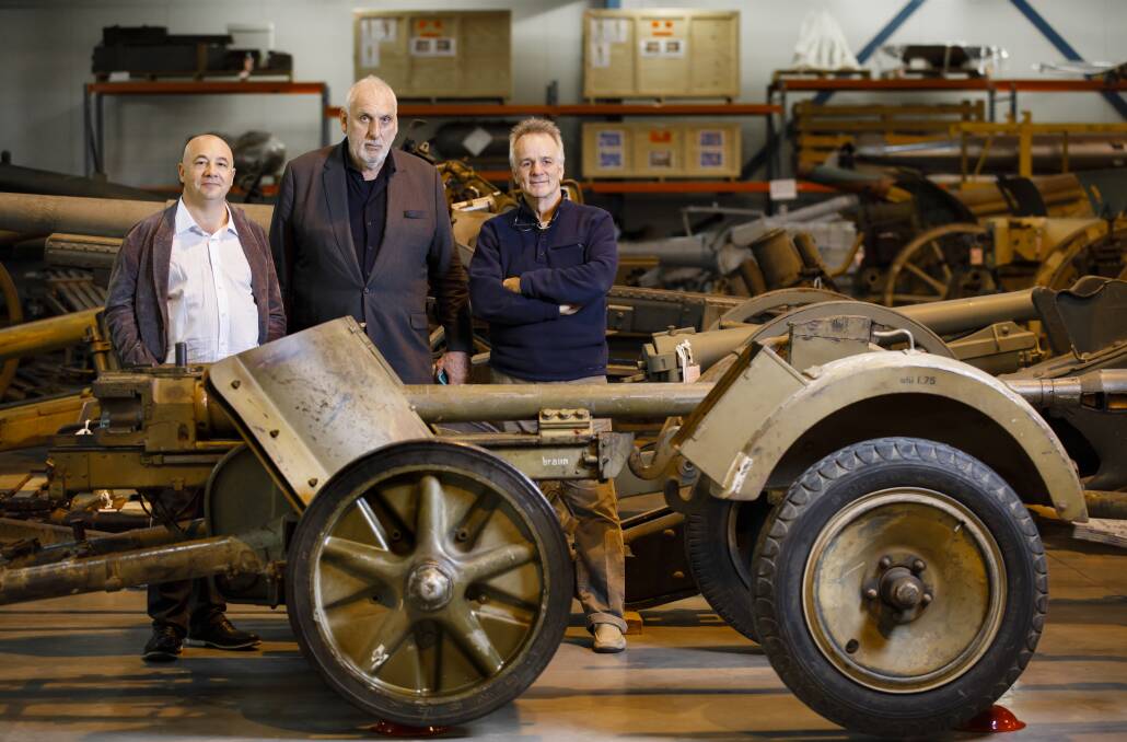 Producer John De Margheriti, director Phillip Noyce, and screenwriter John Collee with a PaK 38 5cm anti-tank gun at the Australian War Memorial Treloar facility where they were conducting research for a film about the Rats of Tobruk.  Photo: Sitthixay Ditthavong