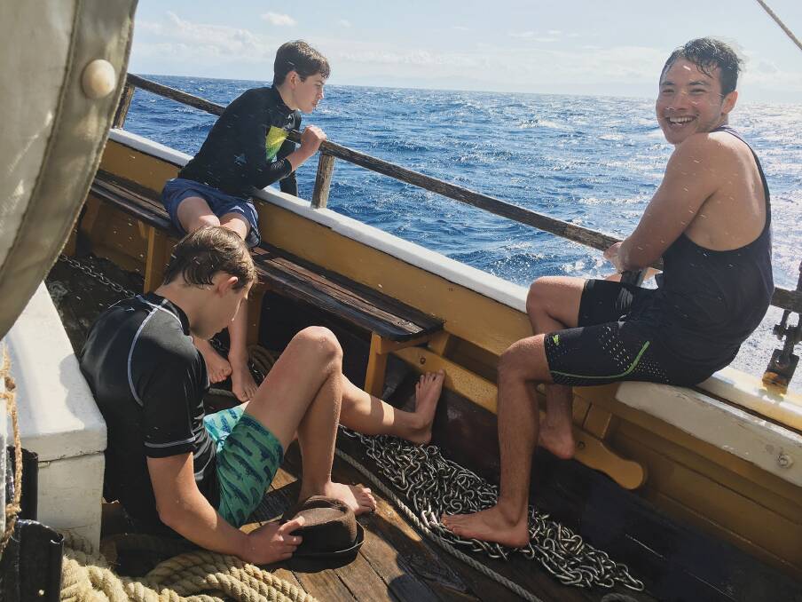 Abdul, with Lucas and Toby, on a sailing boat trip. Now boat trips are fun; this boy has come a long way. Photo: Courtesy of Allen and Unwin