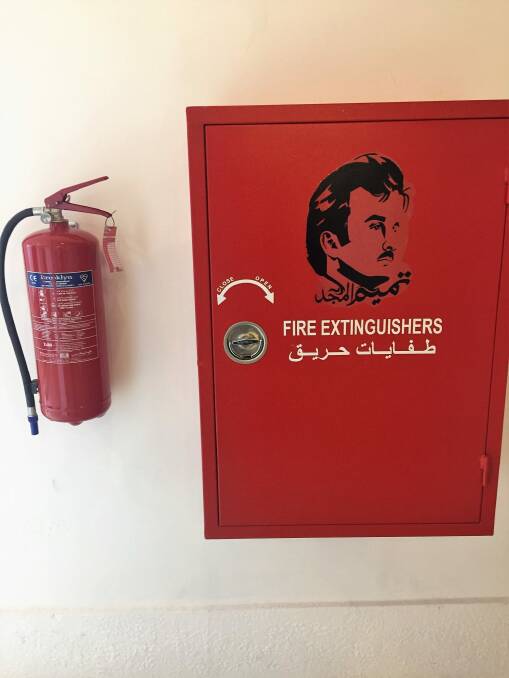A stencil of the Emir's face on a fire extinguisher cabinet in Souq Waqif, Doha.  Photo: Katie Burgess