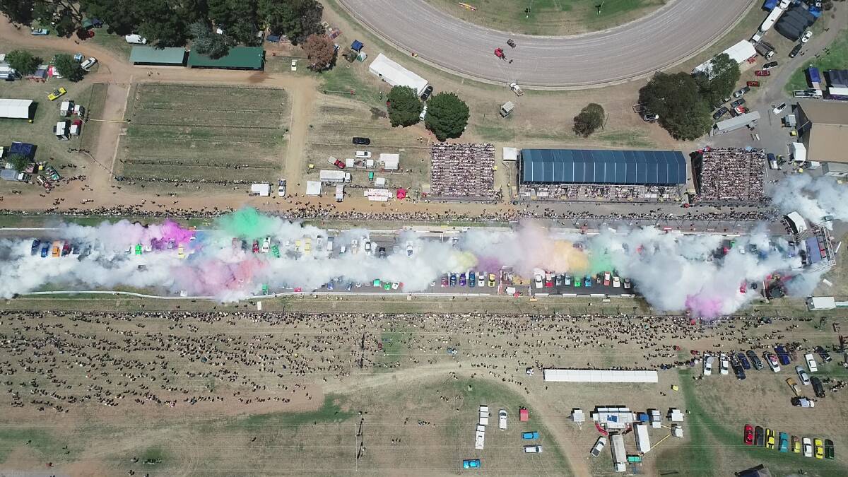 A drone shot of the assembled cars beginning their Summernats burnout record attempt Photo: Supplied