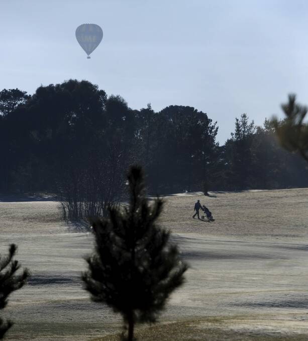 Players were crunching along the frosted fairways
at Royal Canberra Golf Course.  Photo: Graham Tidy