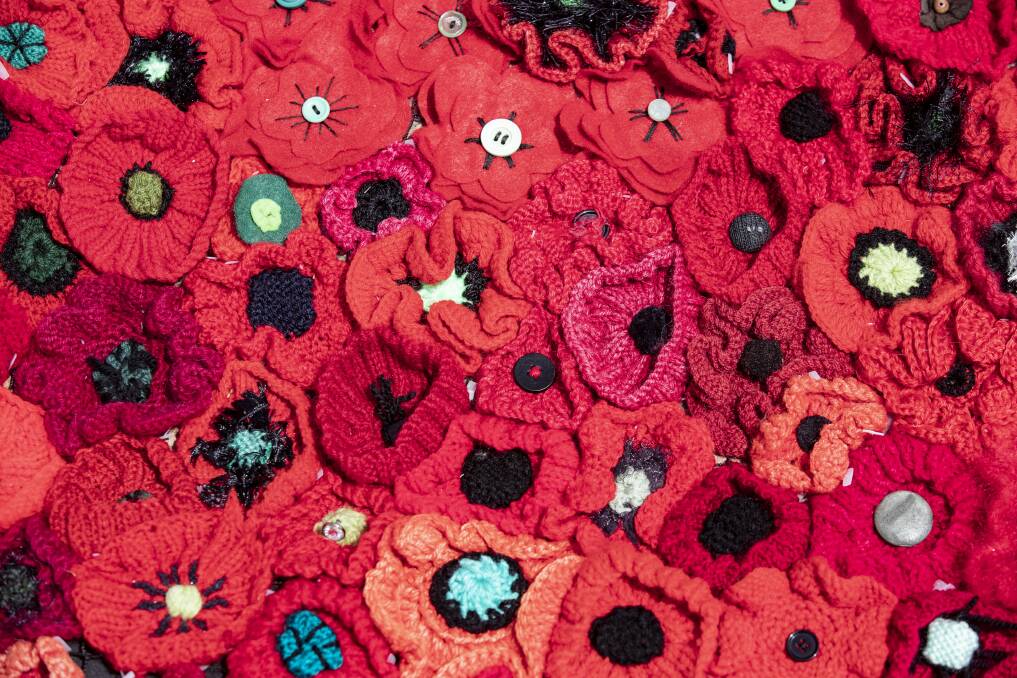 The poppies at Parliament House have been hand-crafted in all shades of red, but also white for nurses and purple for animals, lost in warfare. Photo: Sitthixay Ditthavong