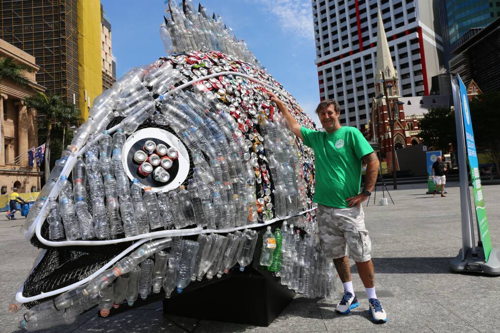 Mackay artist David Day designed a fish sculpture made from 4000 recycled cans and water bottles for the Containers for Change initiative in Queensland. Photo: Jocelyn Garcia