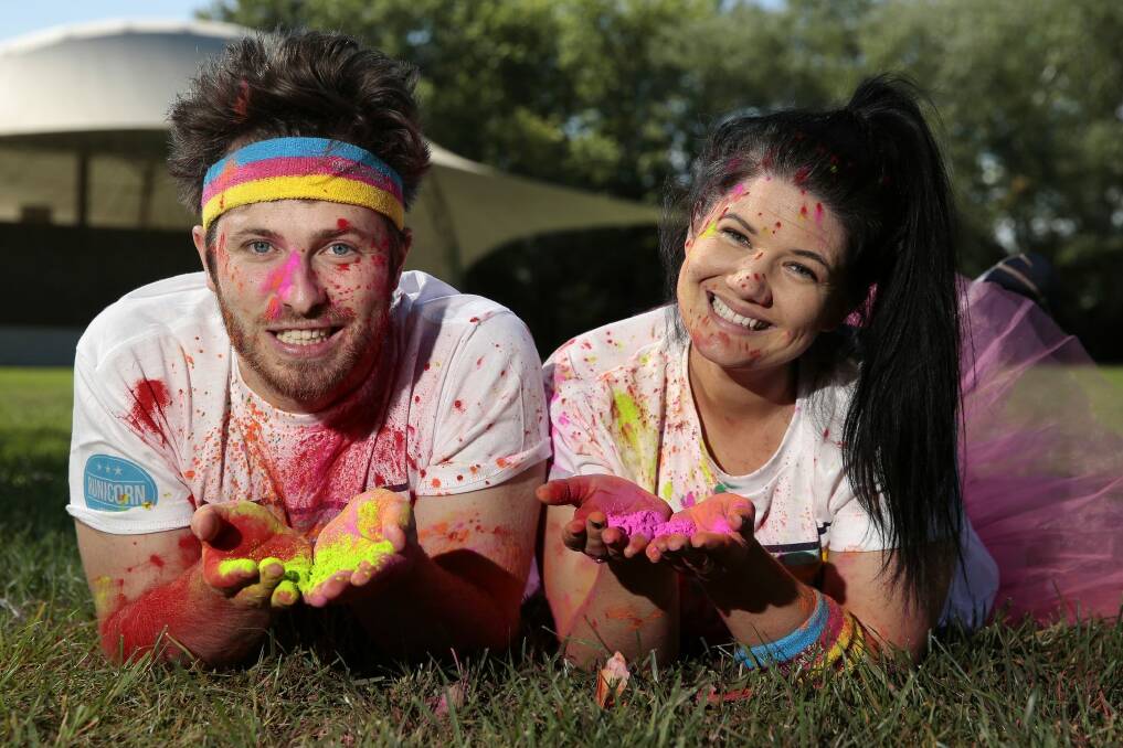 Ryan Jon and Tanya Hennessy threw themselves into Canberra life, including participating in the colour run. Photo: Jeffrey Chan