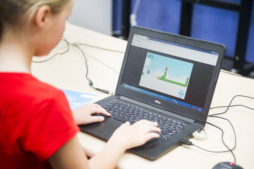 Matilda Bowen playing the game she made during the Code Camp at Holy Spirit Primary School. Photo: Dion Georgopoulos