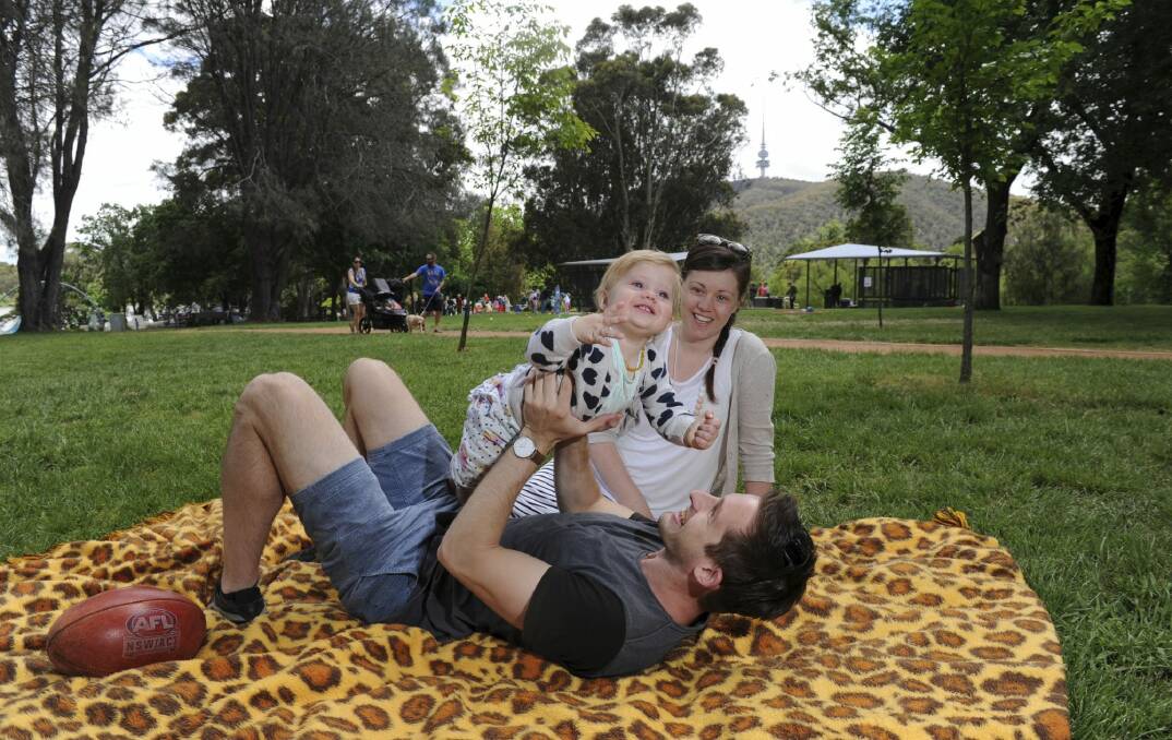 Clair and Jake Gumley of Banks with one-year-old Penelope enjoy the sunshine in front of the new shelters and BBQ area in upgraded Weston Park.  Photo: Graham Tidy