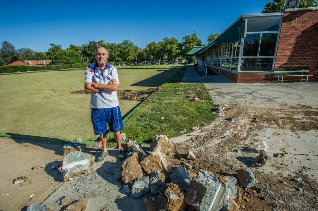 Bob Powell, president of the Canberra City Bowling Club, watched a bobcat tear up the green, marking the club's closure. Photo: Karleen Minney