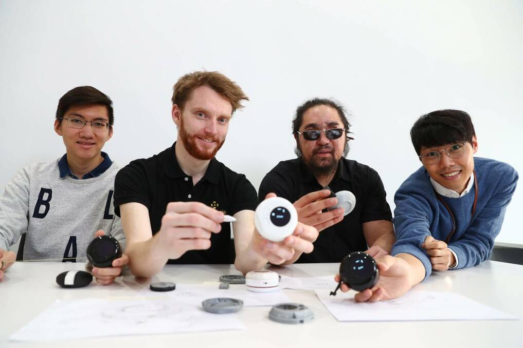 Co-founders of Brisbane start-up OSeyeris Jake Dean (second from left) and Yuma Decaux (third from left) with their digital tape measure for the visually-impaired. Photo: Supplied