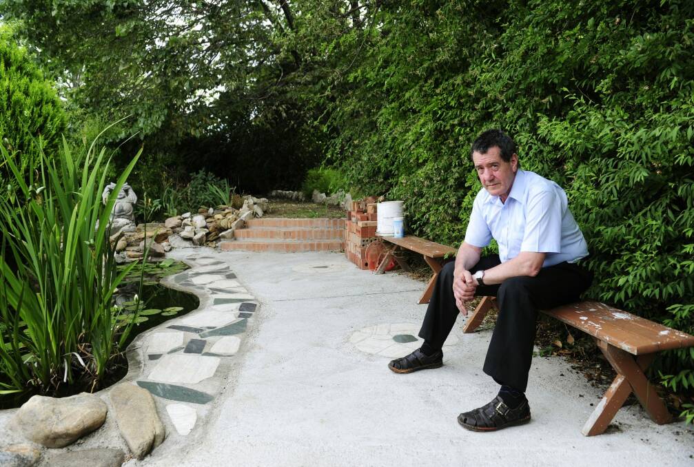 Leo Carvalho reflecting on the ongoing Mr Fluffy debacle in his landscaped garden. Photo: Melissa Adams